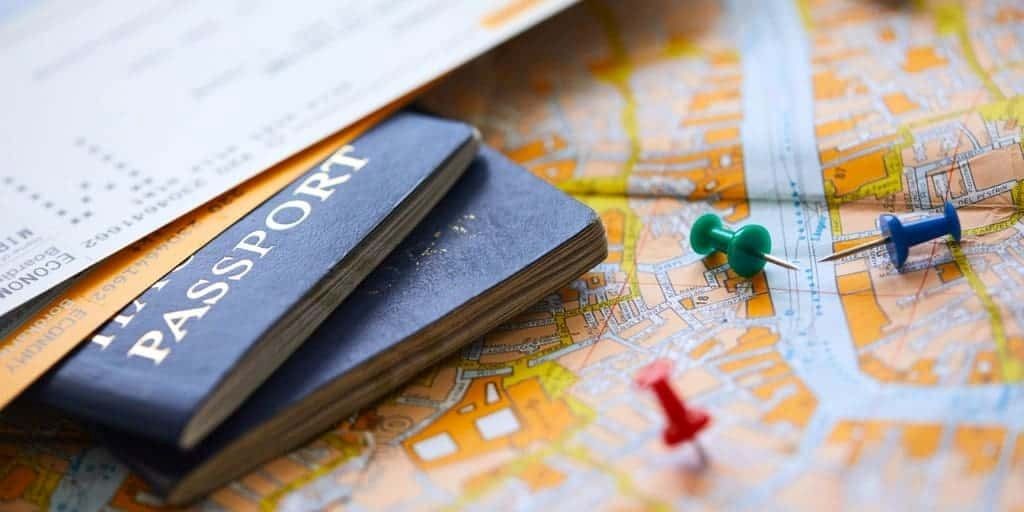 First-time travelers planning a European trip using a map and guidebook