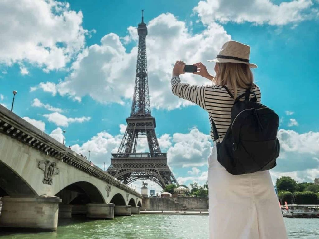 Traveler exploring European landmarks with travel planning tools